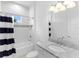 Bright bathroom features white tile, a shower-tub, and a vanity with marble countertop at 17114 Verona Pl, Lakewood Ranch, FL 34202