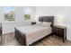Bedroom featuring a bed with patterned linens, two side tables, and window views at 17114 Verona Pl, Lakewood Ranch, FL 34202