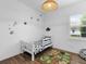 bedroom with dinosaur accents, wood-look floors, and a bright window at 17114 Verona Pl, Lakewood Ranch, FL 34202