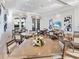 Charming dining area with multiple tables, lots of light, and decorative floral arrangements on the tabletops at 17114 Verona Pl, Lakewood Ranch, FL 34202
