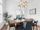Airy dining room with an elegant chandelier, large windows and view of community pool at 17114 Verona Pl, Lakewood Ranch, FL 34202