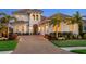 Charming home showcasing a tile roof, paver driveway, and lush landscaping, creating a welcoming facade at 17114 Verona Pl, Lakewood Ranch, FL 34202