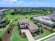 Beautiful property boasting a tile roof, paved driveway, and verdant landscaping, all set against the backdrop of a large pond at 17114 Verona Pl, Lakewood Ranch, FL 34202