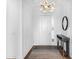 Elegant foyer with sleek console table, decorative mirror, modern light fixture, and pristine white wainscoting at 17114 Verona Pl, Lakewood Ranch, FL 34202