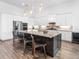 Spacious kitchen features modern appliances, white cabinets, a large island, and stylish bar stool seating at 17114 Verona Pl, Lakewood Ranch, FL 34202