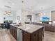 Open-concept kitchen features a large center island, granite countertops, and stainless steel appliances at 17114 Verona Pl, Lakewood Ranch, FL 34202