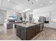 Open kitchen and living room boasts a large island, modern appliances, and seamless access to living space at 17114 Verona Pl, Lakewood Ranch, FL 34202