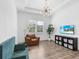 Bright living room featuring modern lighting, plush seating, and a wall-mounted television at 17114 Verona Pl, Lakewood Ranch, FL 34202