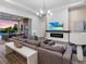 Open living room featuring a fireplace, backyard views, comfortable seating, and a seamless flow to outdoor amenities at 17114 Verona Pl, Lakewood Ranch, FL 34202