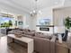 Bright living room with seamless backyard access, a fireplace, and an open layout to outdoor features and amenities at 17114 Verona Pl, Lakewood Ranch, FL 34202