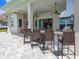 Outdoor bar with comfortable seating, an outdoor kitchen, and seamless indoor-outdoor flow at 17114 Verona Pl, Lakewood Ranch, FL 34202