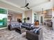 Spacious outdoor living area featuring an outdoor kitchen, comfortable seating, and seamless indoor-outdoor flow at 17114 Verona Pl, Lakewood Ranch, FL 34202