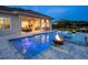 Backyard with luxurious pool and outdoor living space that includes kitchen and seating at 17114 Verona Pl, Lakewood Ranch, FL 34202
