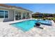 Beautiful pool and outdoor kitchen with bar seating, perfect for entertaining and enjoying outdoor living at 17114 Verona Pl, Lakewood Ranch, FL 34202