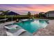 Beautiful pool with water features, fire bowls, chaise loungers, and lush landscaping at 17114 Verona Pl, Lakewood Ranch, FL 34202