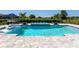 Luxury pool boasts chaise lounges, hammock, spa, and serene views of community at 17114 Verona Pl, Lakewood Ranch, FL 34202
