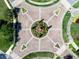 Aerial view of a decorative roundabout with landscaping and a central fountain feature at 17114 Verona Pl, Lakewood Ranch, FL 34202