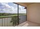 View from the screened balcony overlooks a golf course and scenic water feature at 17118 Vardon Ter # 307, Bradenton, FL 34211
