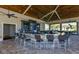 Outdoor bar with granite countertop, TV and wood ceiling provides a great entertainment space at 17118 Vardon Ter # 307, Bradenton, FL 34211