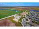 Aerial shot of the community clubhouse, parking area, and nearby golf course on a sunny day at 17118 Vardon Ter # 307, Bradenton, FL 34211