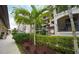 Attractive condo building exterior showcases palm trees, manicured landscaping and an elegant stone facade with wrought iron balconies at 17118 Vardon Ter # 307, Bradenton, FL 34211