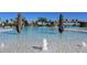 A sparkling pool with a rock waterfall feature and clear blue water invites you to relax and enjoy the Florida sunshine at 17118 Vardon Ter # 307, Bradenton, FL 34211