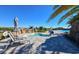 Relaxing pool area featuring lounge chairs, umbrellas, and a tranquil spa with waterfall feature, creating a luxurious retreat at 17118 Vardon Ter # 307, Bradenton, FL 34211