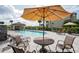 Inviting community pool with lounge chairs, umbrella-covered tables, and a covered pavilion for relaxation and enjoyment at 17118 Vardon Ter # 307, Bradenton, FL 34211