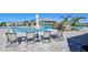 Relax on the spacious pool deck with comfortable lounge chairs and umbrellas, overlooking the waterfall feature and lush landscape at 17118 Vardon Ter # 307, Bradenton, FL 34211