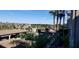 A view from a balcony, with palm trees and community buildings in the distance at 17118 Vardon Ter # 307, Bradenton, FL 34211
