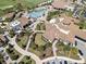 An impressive aerial view shows the community's luxurious clubhouse, pool, and well-manicured landscaping at 17902 Gawthrop Dr # 401, Bradenton, FL 34211