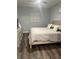 Inviting bedroom featuring wooden flooring and cozy neutral colored bedding, plus calming natural light at 17902 Gawthrop Dr # 401, Bradenton, FL 34211