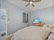 Cozy bedroom with a ceiling fan, neutral-toned bedding, and bright natural light at 17902 Gawthrop Dr # 401, Bradenton, FL 34211
