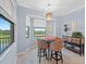 Bright dining area featuring large windows with scenic views, charming chairs, and pendant lighting at 17902 Gawthrop Dr # 401, Bradenton, FL 34211