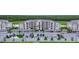 Exterior view of the condominium building with covered parking and manicured landscaping at 17902 Gawthrop Dr # 401, Bradenton, FL 34211