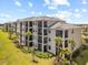 The exterior features screened in patios, lush lawns, and attractive landscaping with palm trees at 17902 Gawthrop Dr # 401, Bradenton, FL 34211