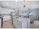 Open-concept kitchen with large island, stainless steel appliances, and seamless flow to living area at 17902 Gawthrop Dr # 401, Bradenton, FL 34211