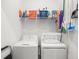 Functional laundry room with washer, dryer, and storage shelf at 17902 Gawthrop Dr # 401, Bradenton, FL 34211