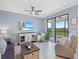 The living room has neutral decor, a ceiling fan, and access to a balcony with outdoor views at 17902 Gawthrop Dr # 401, Bradenton, FL 34211