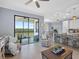Bright living room featuring a sliding glass door to a balcony with scenic views at 17902 Gawthrop Dr # 401, Bradenton, FL 34211