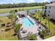 Aerial view of a sparkling community pool surrounded by lush landscaping and lounge chairs at 17902 Gawthrop Dr # 401, Bradenton, FL 34211