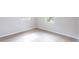 A bright empty bedroom showcases light wood floors and white trim at 1823 8Th E Ave, Bradenton, FL 34208
