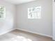 Bright bedroom with light wood floors and two windows at 1823 8Th E Ave, Bradenton, FL 34208