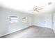 Bedroom showcasing neutral paint, a ceiling fan, and two windows at 1823 8Th E Ave, Bradenton, FL 34208