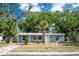 Charming single-story home features a well-maintained front yard with mature trees and a cozy entrance at 1823 8Th E Ave, Bradenton, FL 34208
