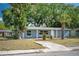 Attractive single-story house displays a lush front yard with mature trees providing ample shade and curb appeal at 1823 8Th E Ave, Bradenton, FL 34208
