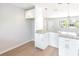Bright kitchen featuring white cabinets, granite countertops, and a breakfast bar at 1823 8Th E Ave, Bradenton, FL 34208