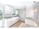 Stylish kitchen with granite countertops, white cabinets, and stainless steel sink with access to the backyard at 1823 8Th E Ave, Bradenton, FL 34208