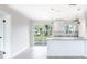 Bright kitchen featuring granite counters, stainless steel appliances, white cabinets and large sliding door to backyard at 1823 8Th E Ave, Bradenton, FL 34208