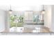 Elegant kitchen showcases granite countertops, shaker style white cabinets and new fixtures with views to the backyard at 1823 8Th E Ave, Bradenton, FL 34208